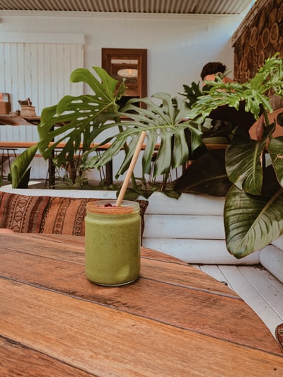 Green potted plant brown wooden table
